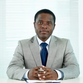 Portrait of confident African businessman looking at camera in office